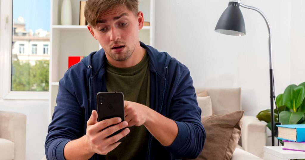 Person scrolling on phone while ignoring the time, showing distraction.