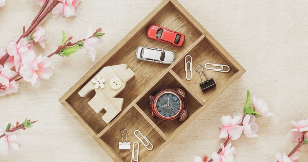 A small entry table with keys, wallet, and sunglasses organized neatly.