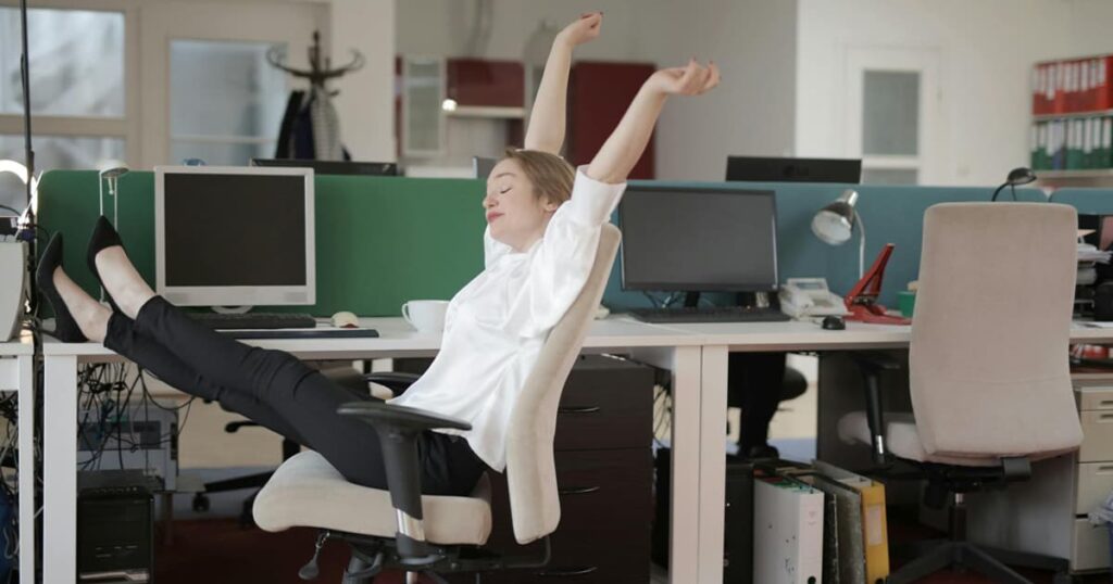A person stretching their arms happily during a break, while a timer shows 5 minutes.