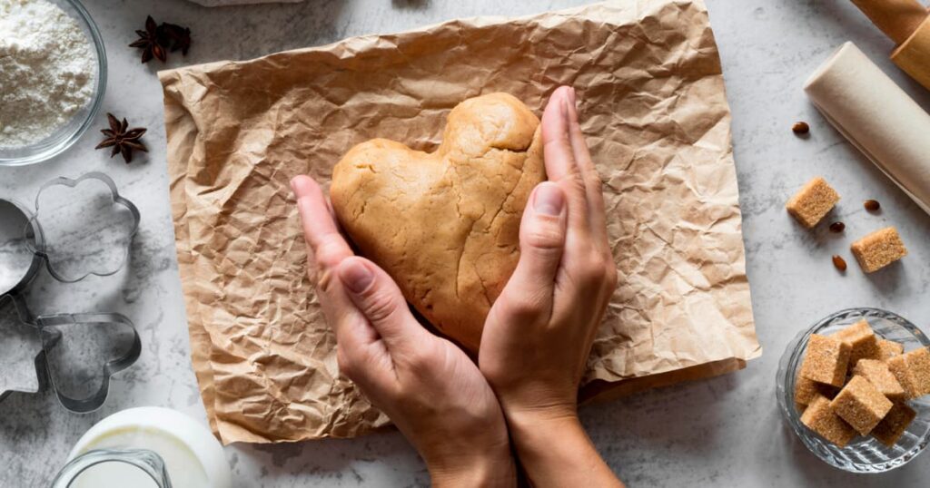 Hands kneading dough or organizing a drawer, showing a small productive task.