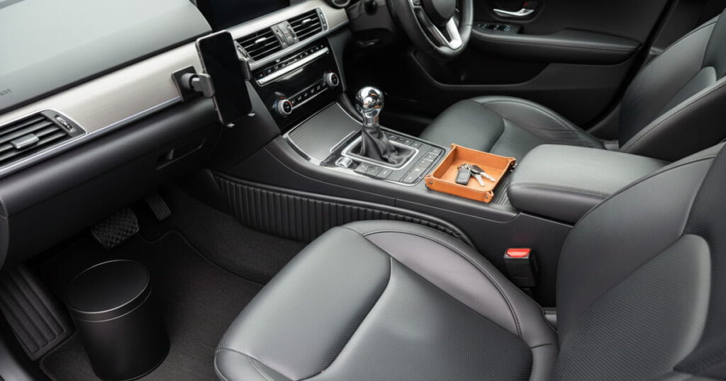 Organized car interior with seat gap filler and trash can. Text overlay: 5 Car Organization Hacks.