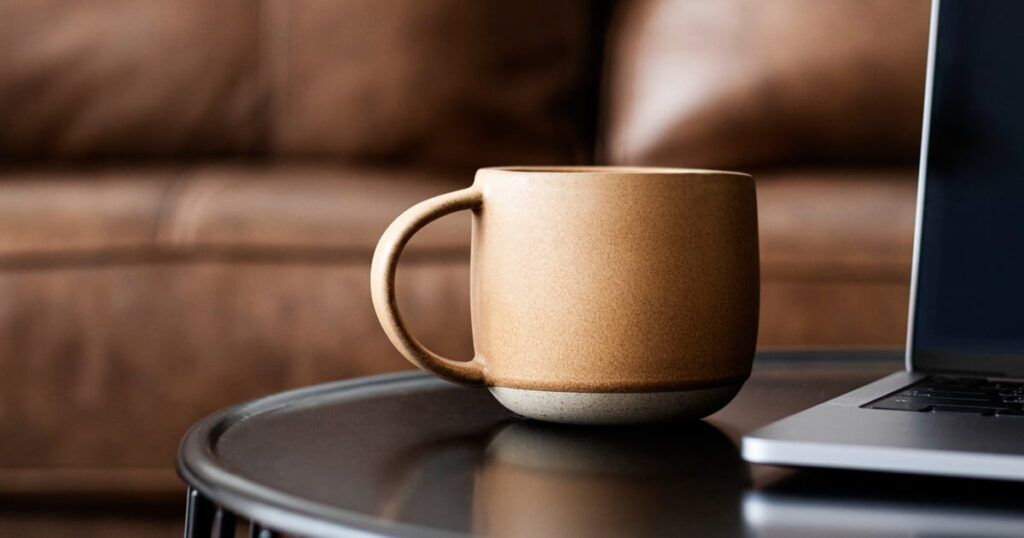 Aesthetic ceramic travel coffee mug on a desk