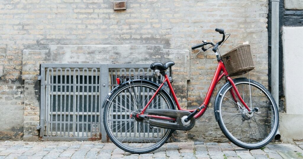 A vintage bicycle leaning against a wall, evoking nostalgia for childhood fun.