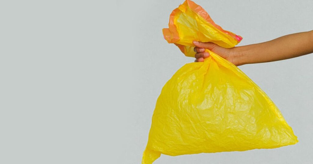 A plastic bag filled with vinegar tied around a showerhead to clean it.