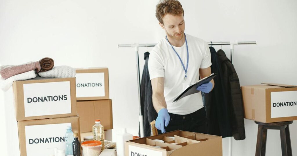 A cardboard box filled with household items ready to be donated to charity.