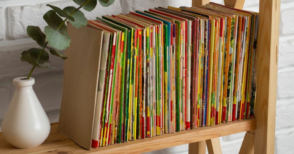 A stack of beautiful, colorful notebooks sitting on a shelf, completely unused.