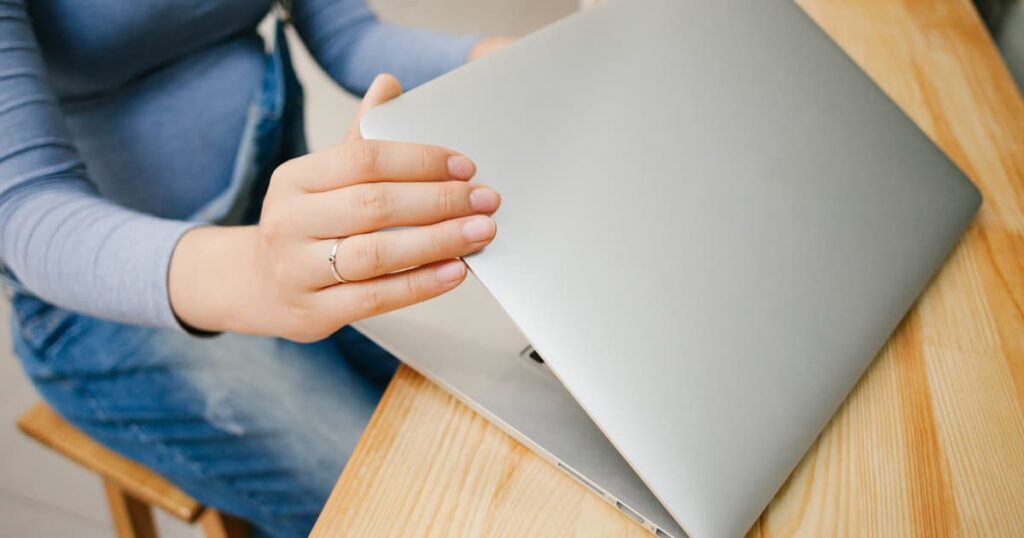 A person closing their notebook with a satisfied smile, ready to relax for the evening.