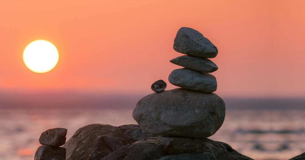 Stones stacked perfectly in balance representing the stability of habit stacking.