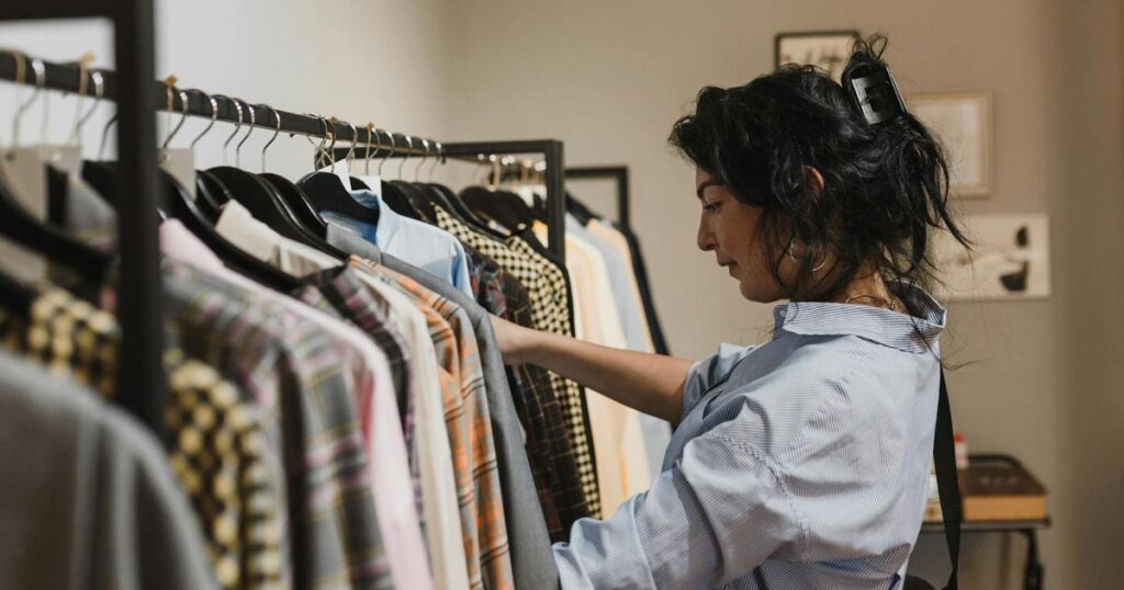 A closet rod showing some hangers facing forward and some facing backward to track usage.