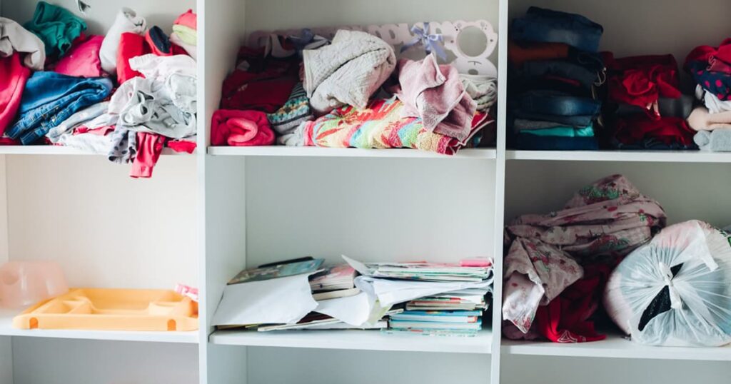 A closet shelf stuffed with random items saved for hypothetical future use.