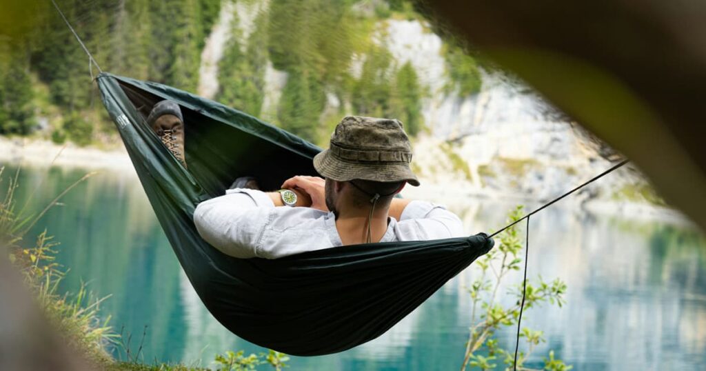 A happy person relaxing in a hammock representing the ultimate goal of the Lazy Smart philosophy.
