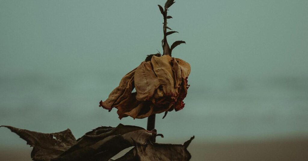 An illustration of a person with a low battery symbol hovering over their head in a dark room.