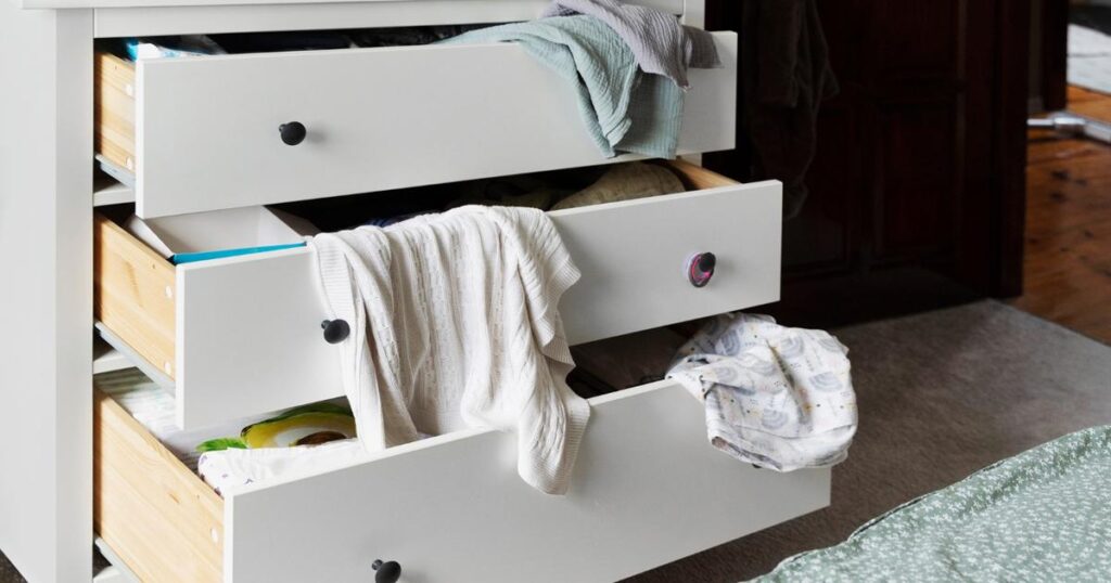 A messy junk drawer filled with random household items.