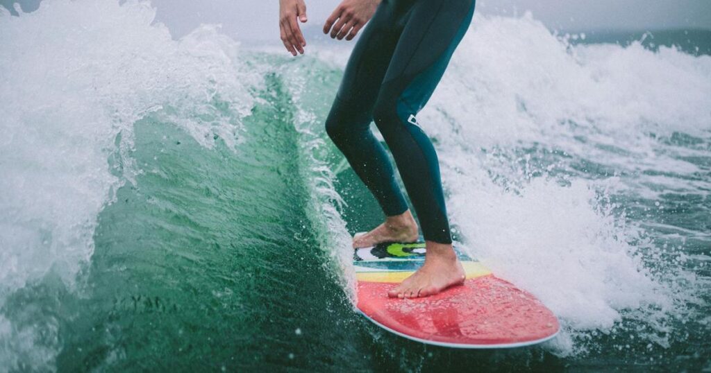 A surfer riding a wave smoothly representing the ease of using existing momentum.