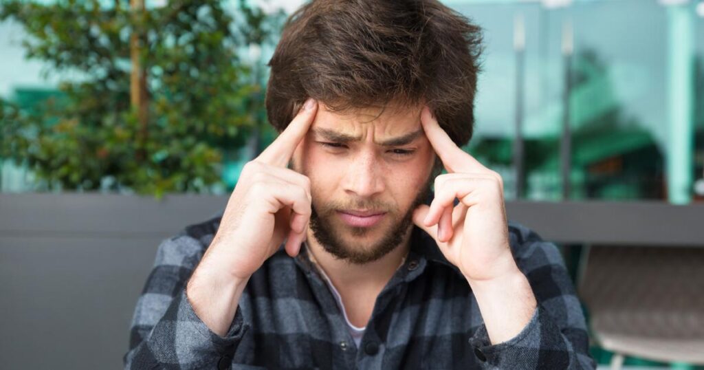 A confused worker trying to switch between too many different tasks at once.