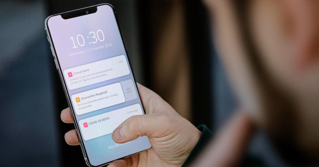 A smartphone lock screen filled with a long list of unread message notifications.