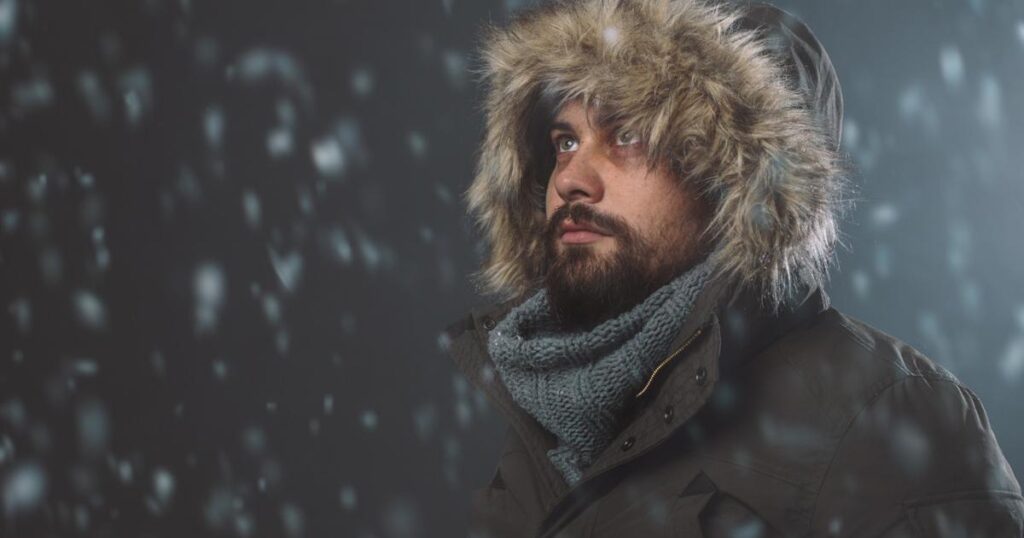 A stressed person staring at a blank computer screen, trapped by the need for perfection.