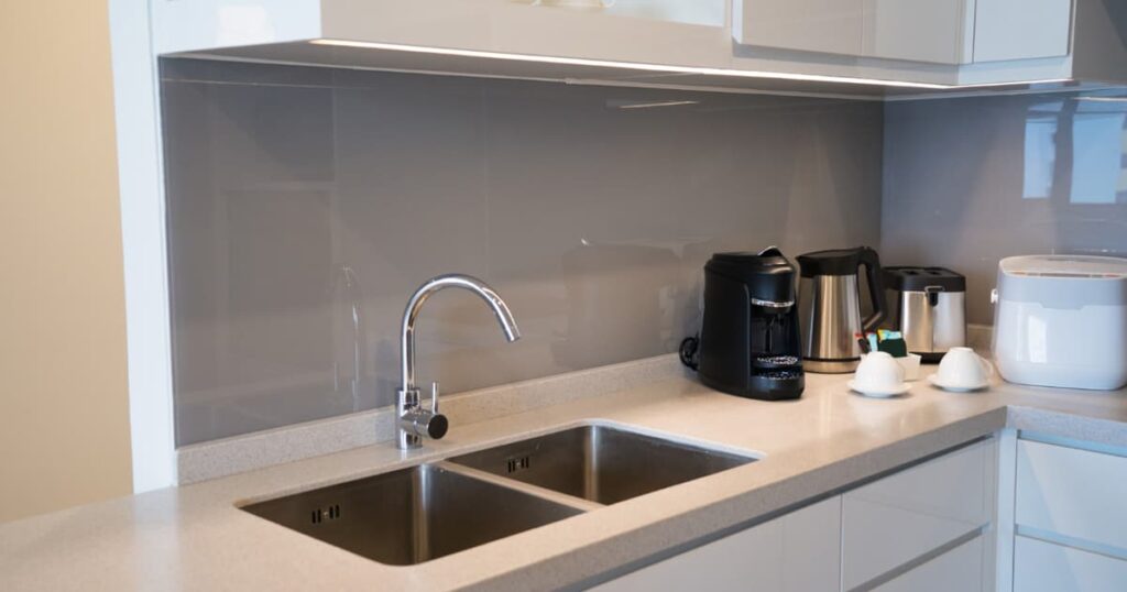 A sparkling clean, minimalist kitchen counter that looks professionally cleaned.