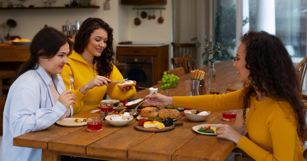 A small group of friends enjoying a meal together, focusing on quality time over quantity.