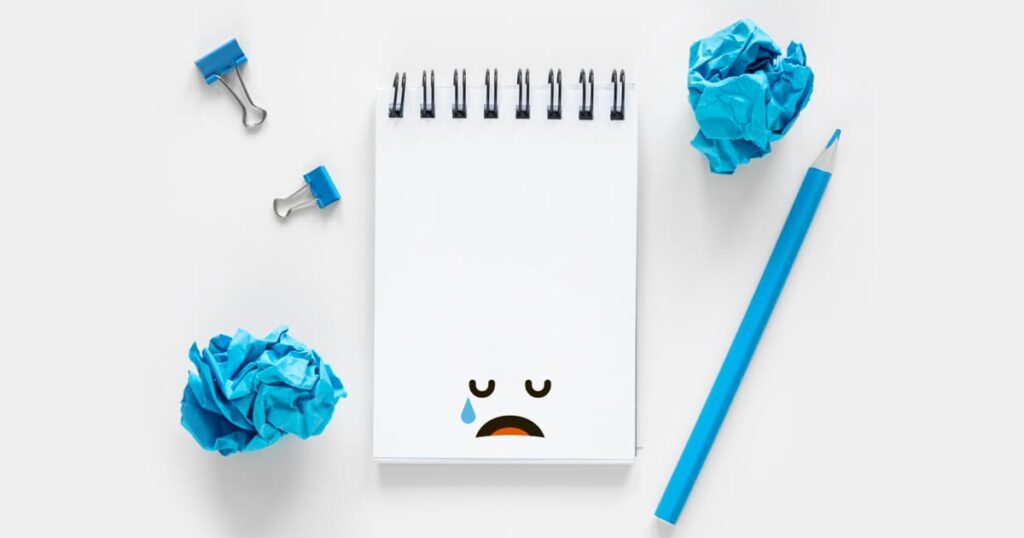 An open notebook with a messy scribble or a grocery list on the very first page.