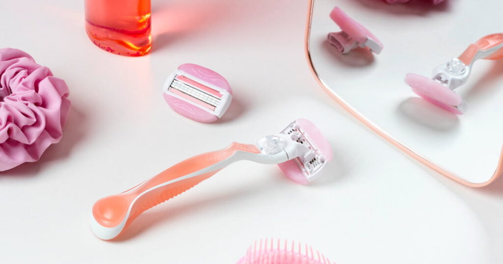 Aesthetic bathroom setup with shaving hacks including rose gold razor and crystal hair eraser