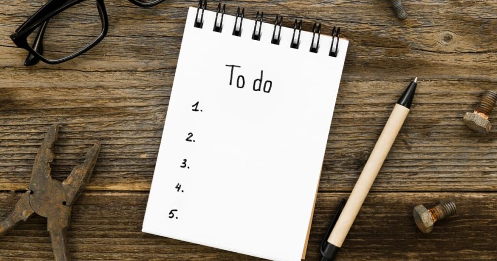 A notepad showing a list of small, easy tasks like "Water plants" and "Load dishwasher."