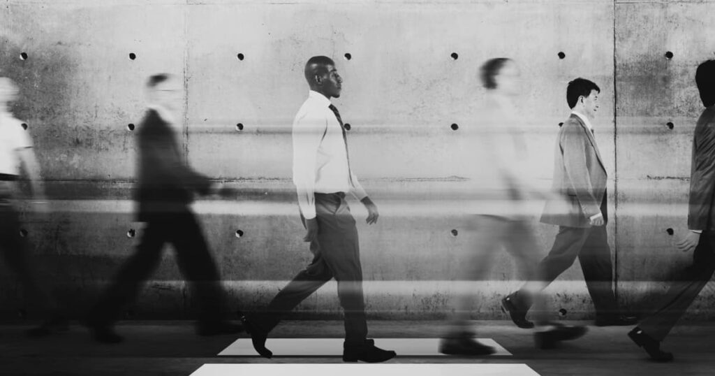 A crowd of people walking on a street, blurred out, showing how quickly we forget strangers.