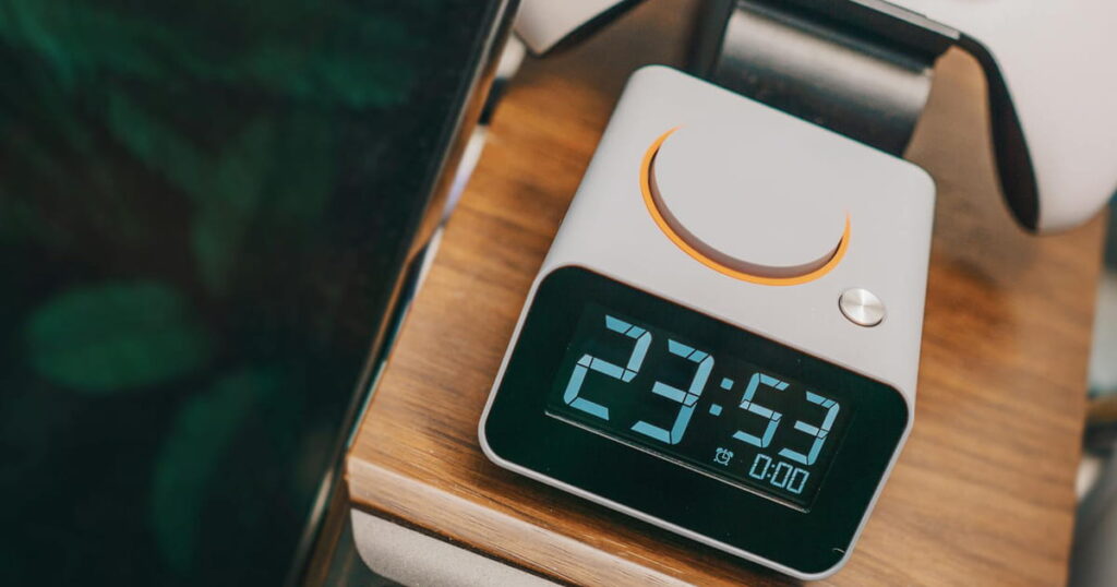 Sunrise alarm clock glowing on a nightstand