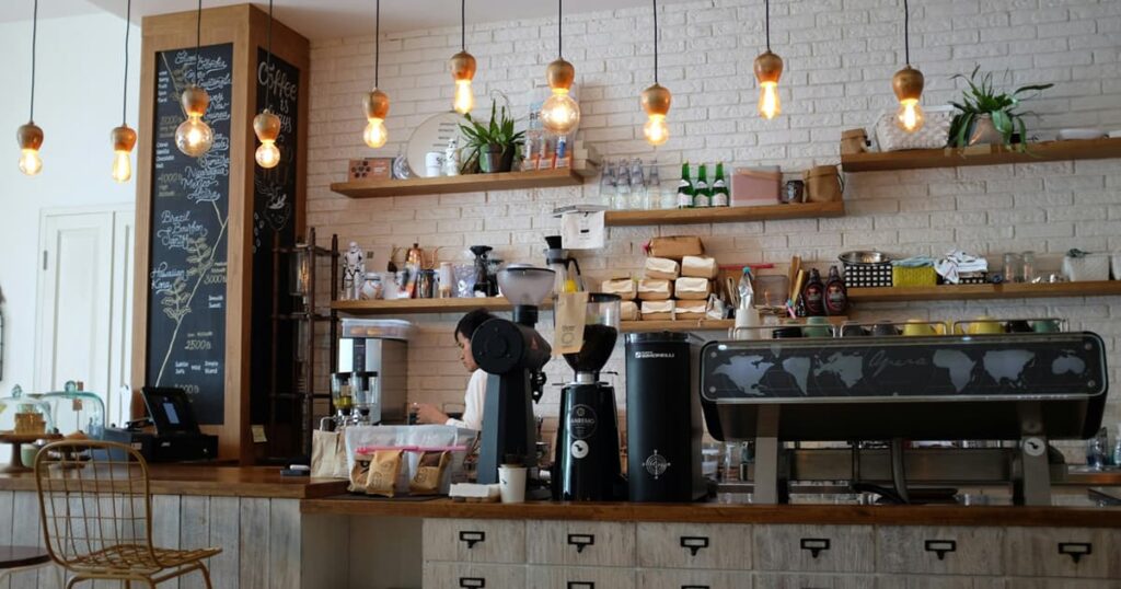 An inviting coffee shop or community park with people talking, representing a welcoming "Third Place."