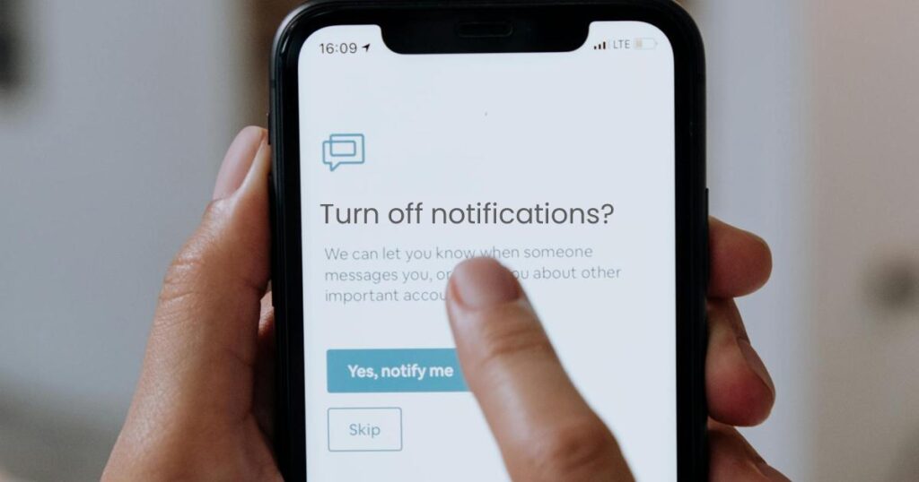 A finger toggling a "Notifications" switch to "Off" on a smartphone settings screen.