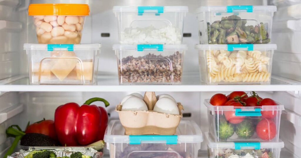 Aesthetic fridge organization featuring clear bins, can dispenser, and lazy susan