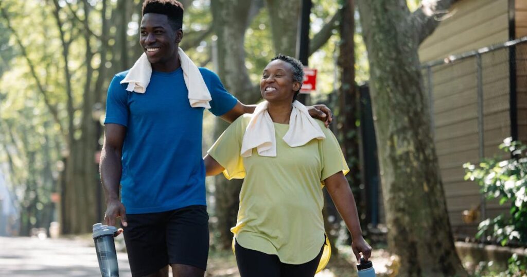 A person walking happily in a park wearing comfortable sneakers.